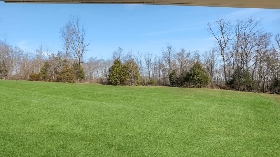 Exterior of home with large backyard.