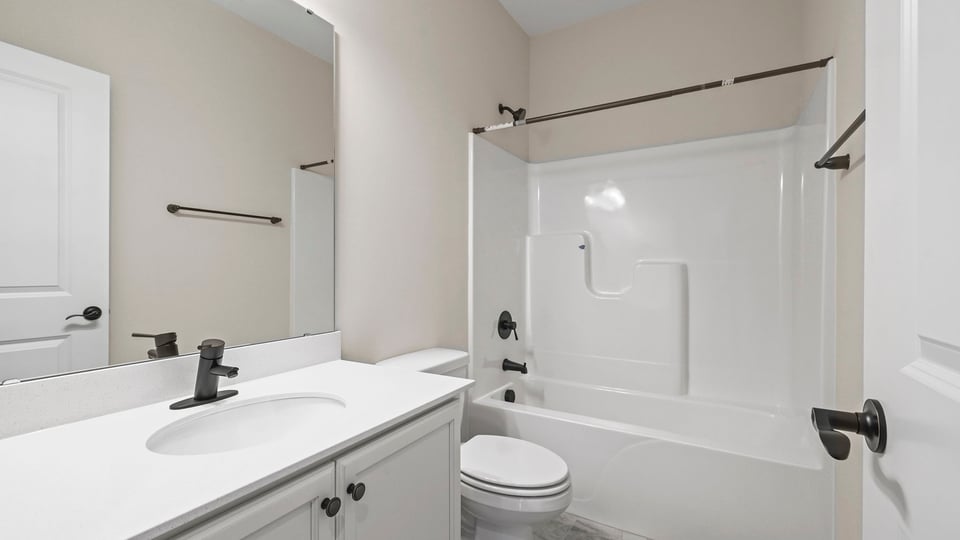 Bthroom with vanity and tub.