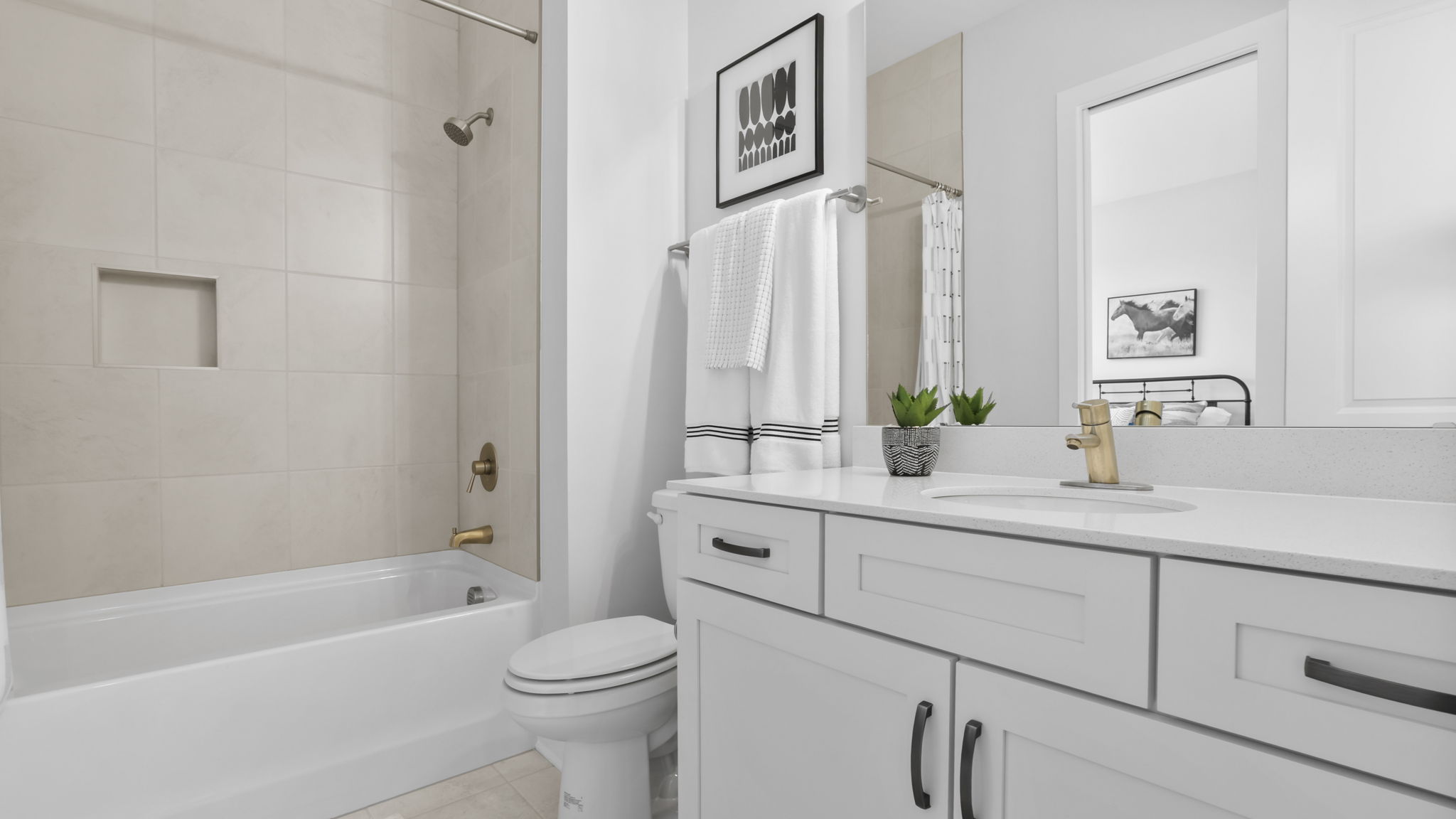 Bathroom with double vanity sink and tub.