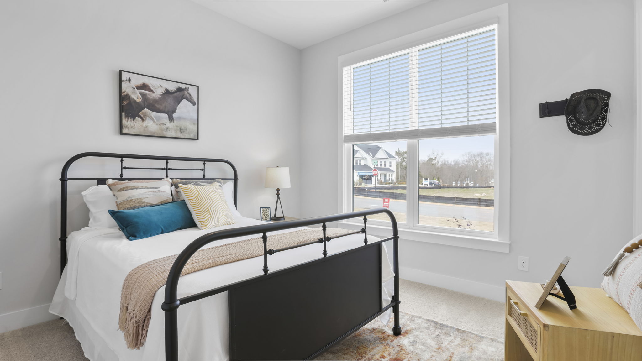 Bedroom with carpet and window.