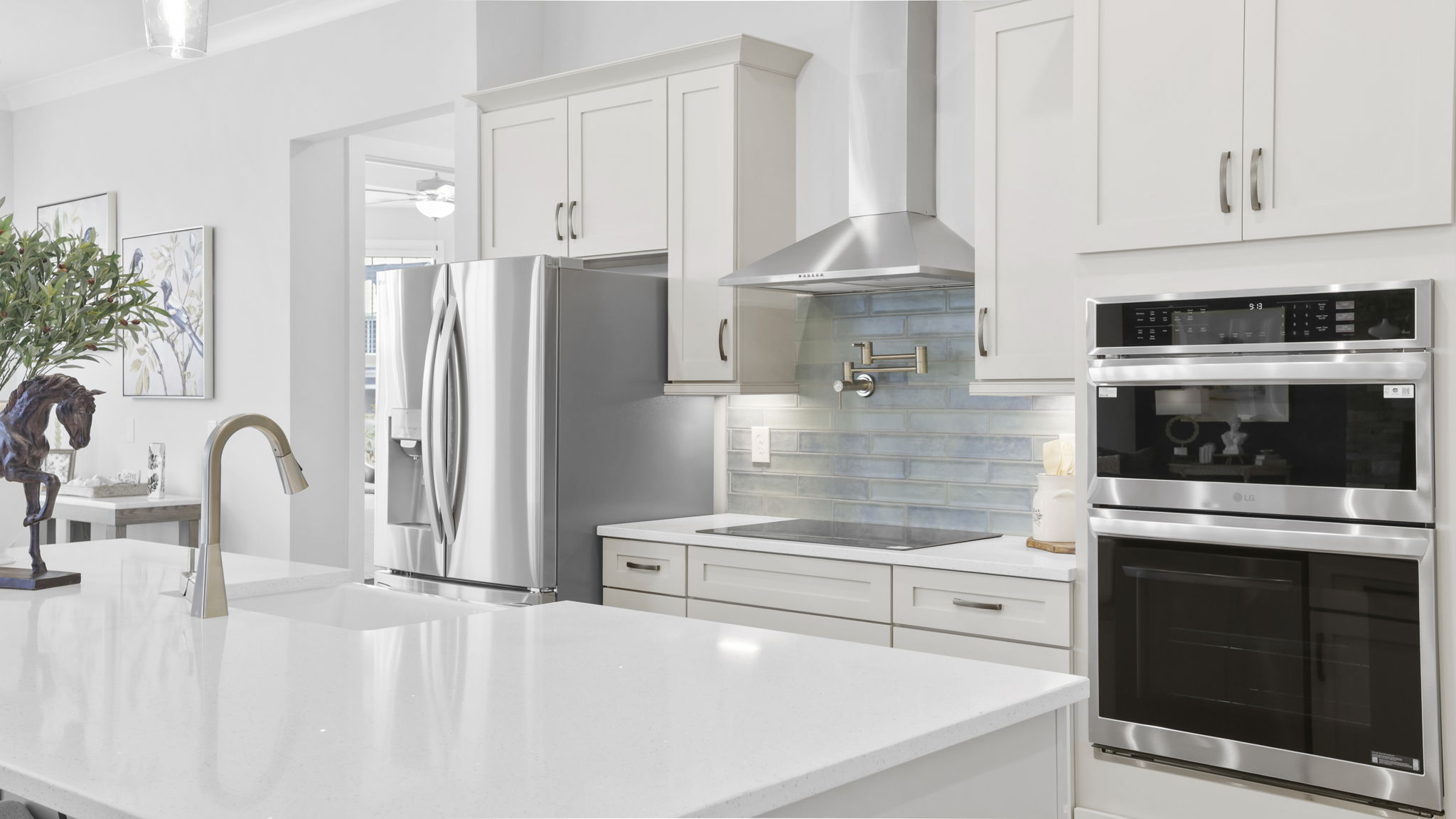 Kitchen and island with quartz countertops.