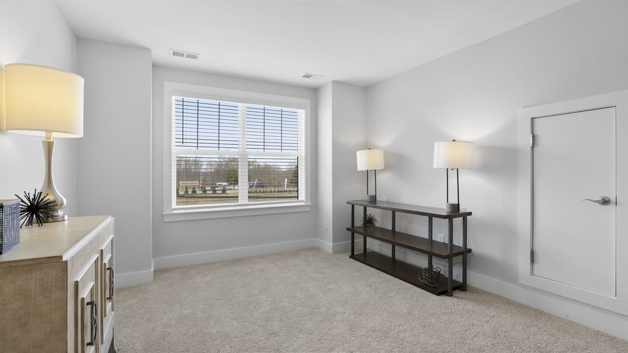 Bedroom with carpet and window.