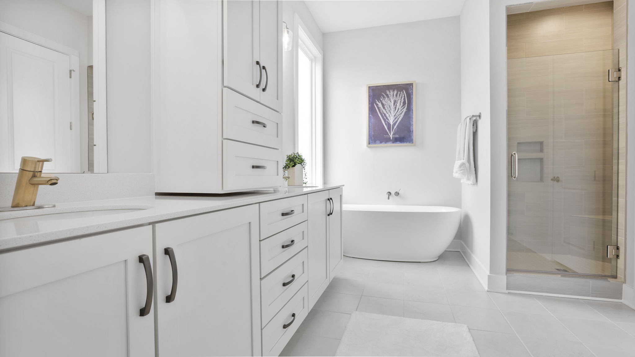 Bathroom with double vanity sink and walk in shower.