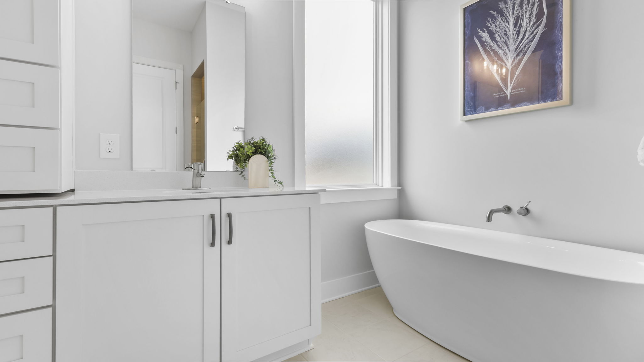 Bathroom with double vanity sink and walk in shower.