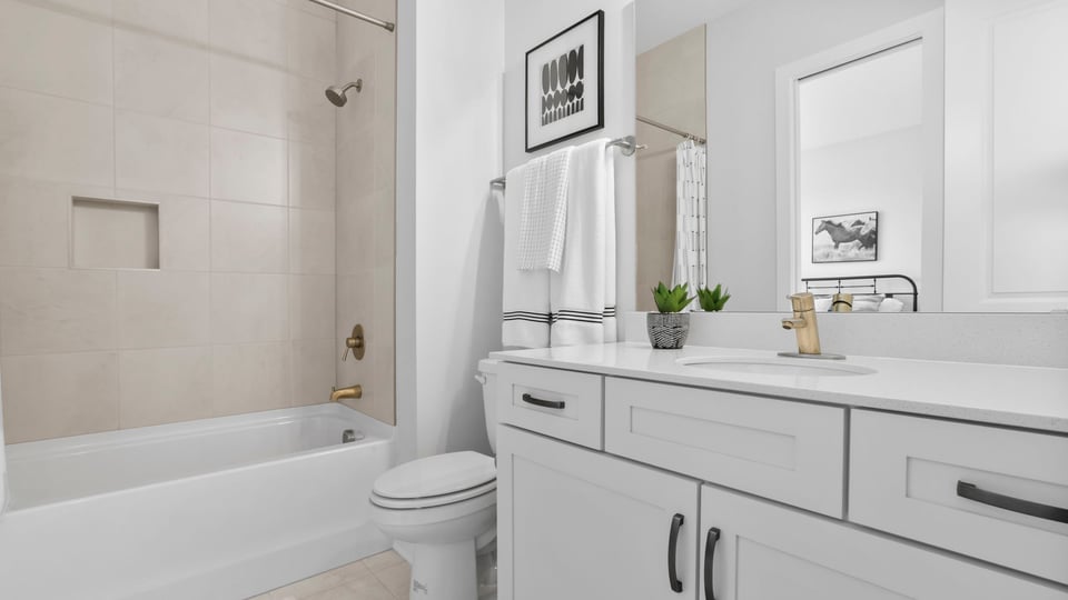 Bathroom with tub and  double sink vanity.