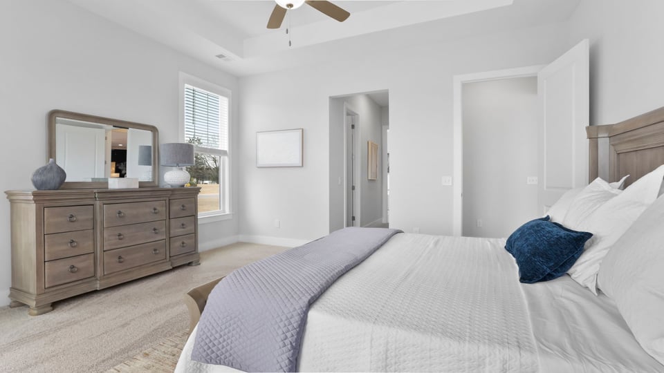 Bedroom with window and carpet.