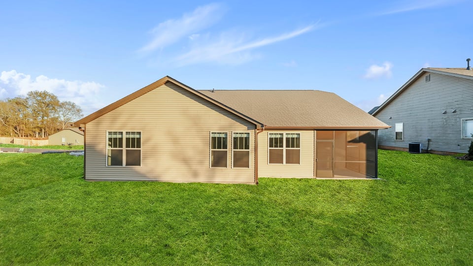 Exterior of home with large backyard.