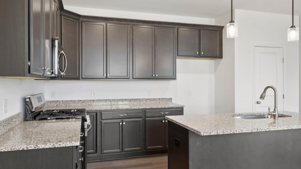 Kitchen with island and cabinets.