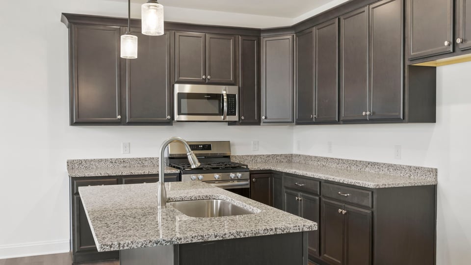 Kitchen with island and cabinets.