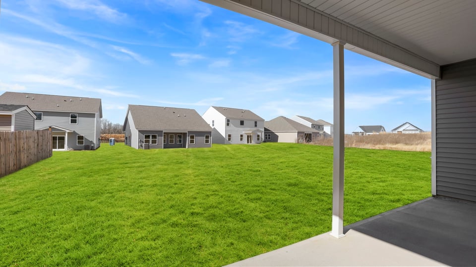 Back exterior with large backyard.