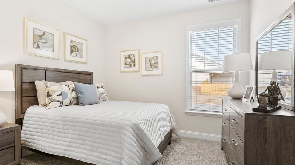 Bedroom with carpet and window.