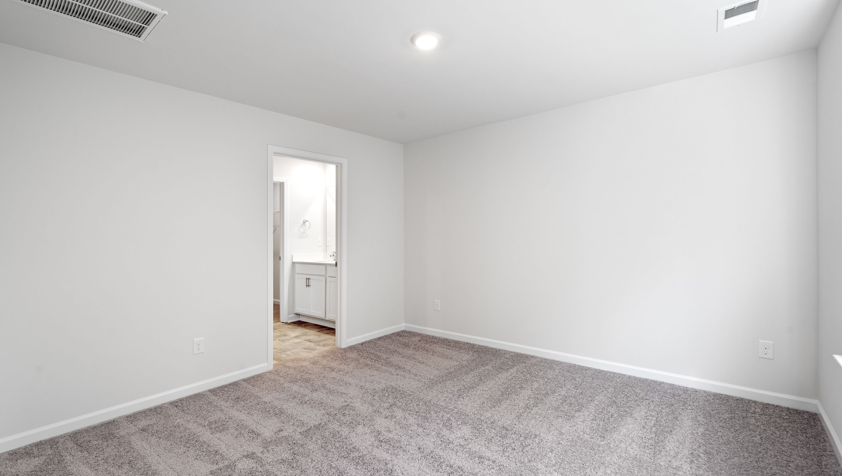 Bedroom with carpet and window.