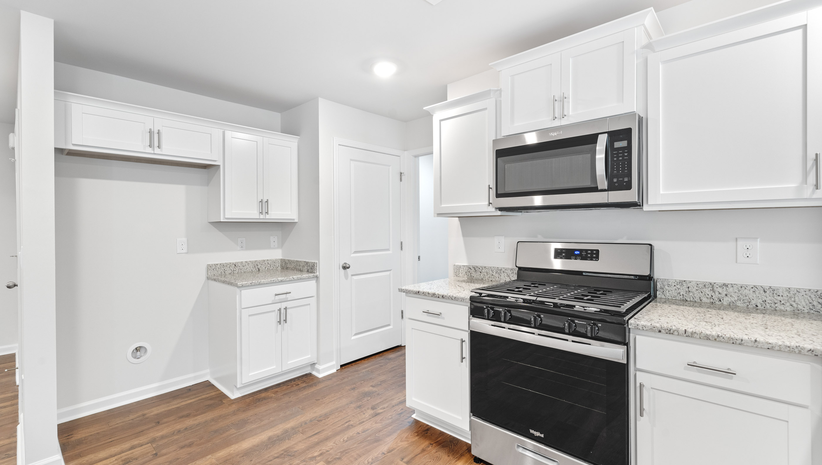 Kitchen with granite countertops and stainless steel appliances.
