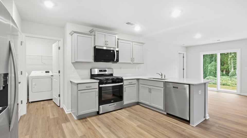 Kitchen with cabinets and window.
