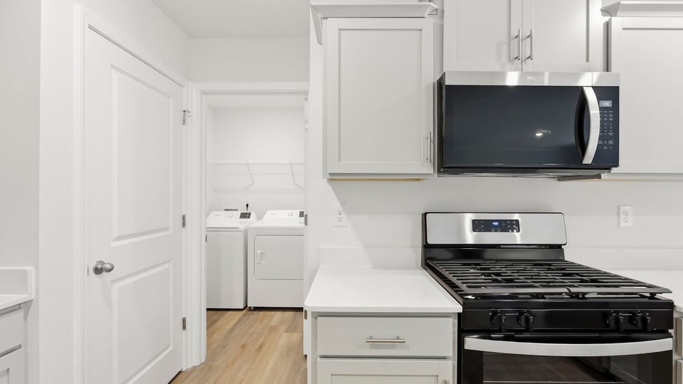 Kitchen with cabinets and window.