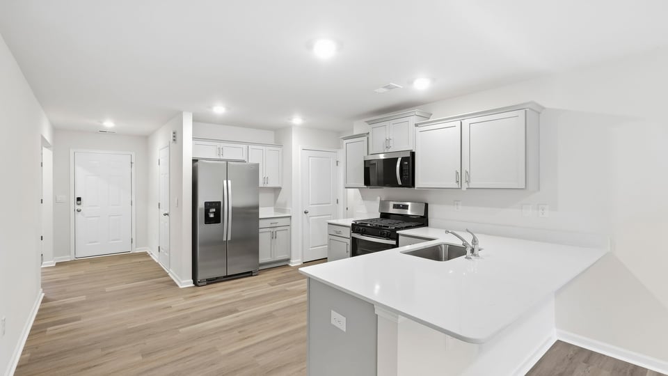 Kitchen with cabinets and window.