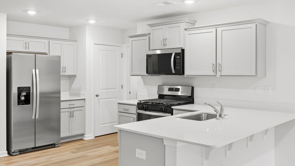 Kitchen with cabinets and window.