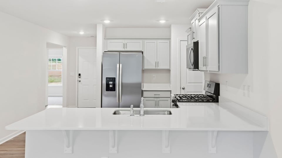 Kitchen with cabinets and window.