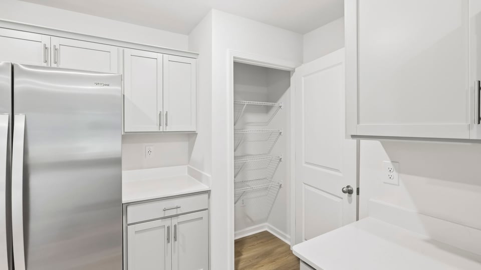 Kitchen with cabinets and window.