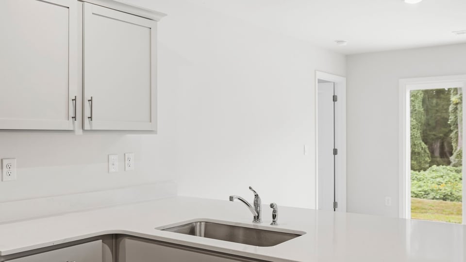 Kitchen with cabinets and window.