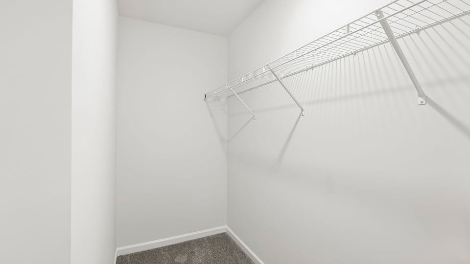 Primary closet with shelf.