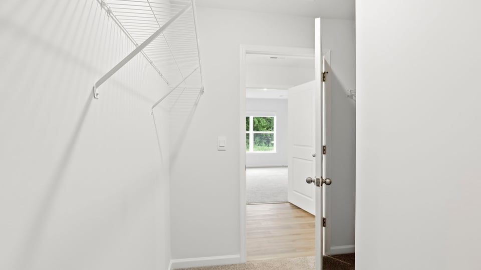 Primary closet with shelf.