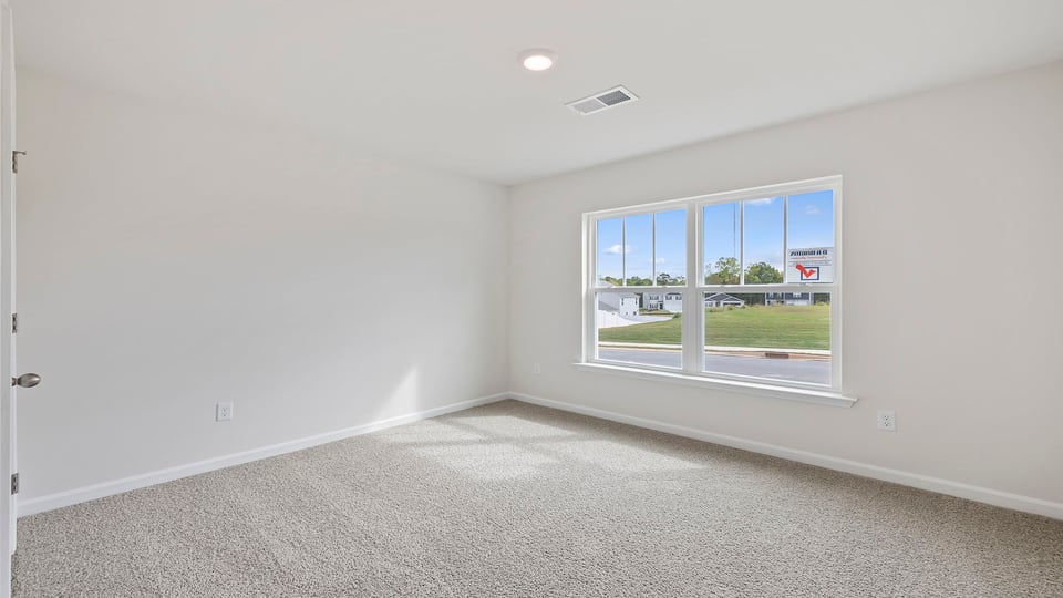 Bedroom with carpet and window.