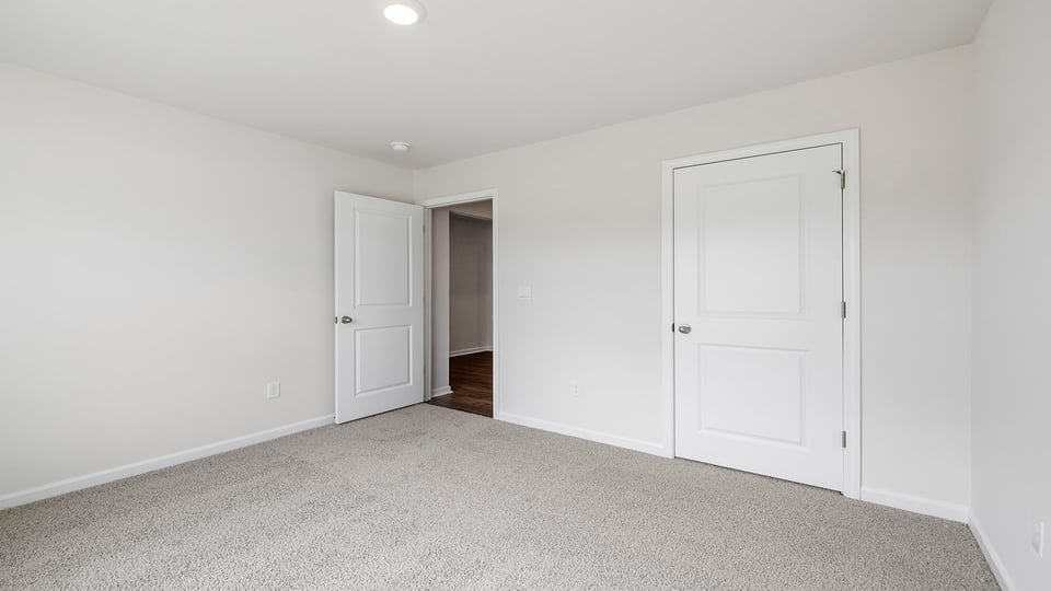Bedroom with carpet and window.