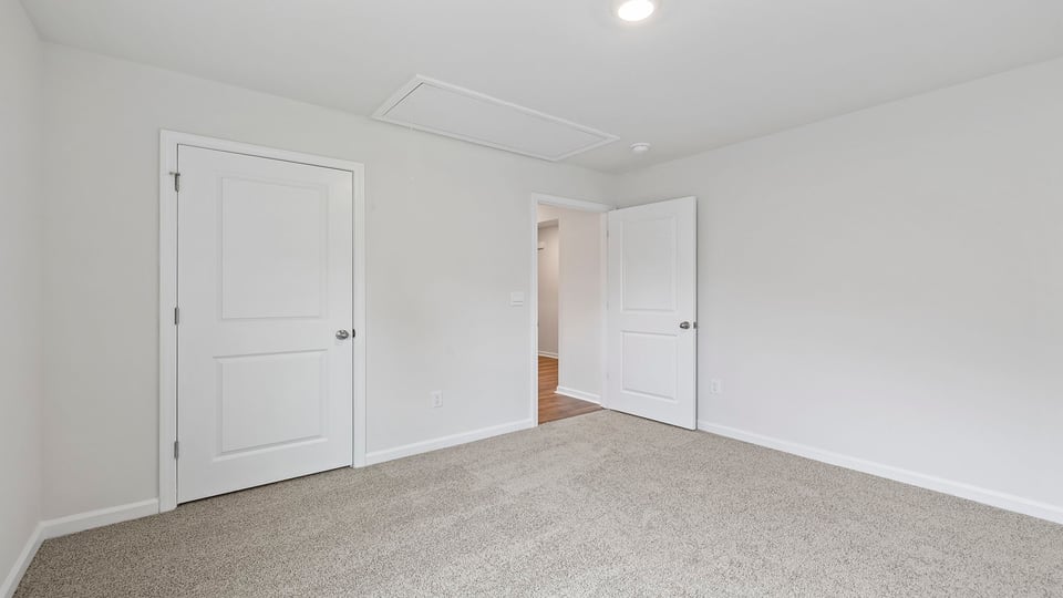 Bedroom with carpet and window.