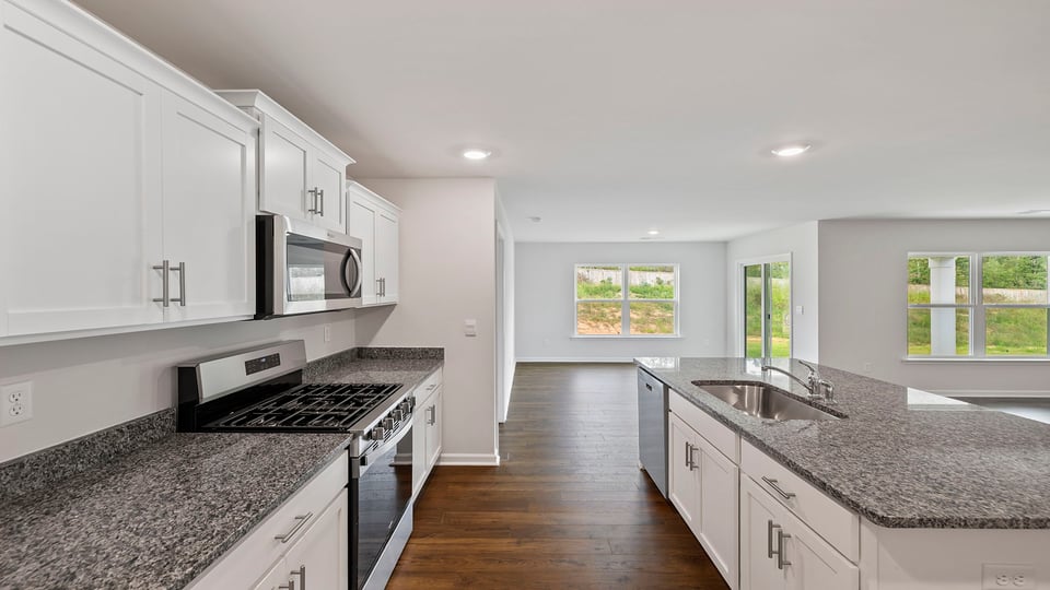 Kitchen and island with granite counter tops.