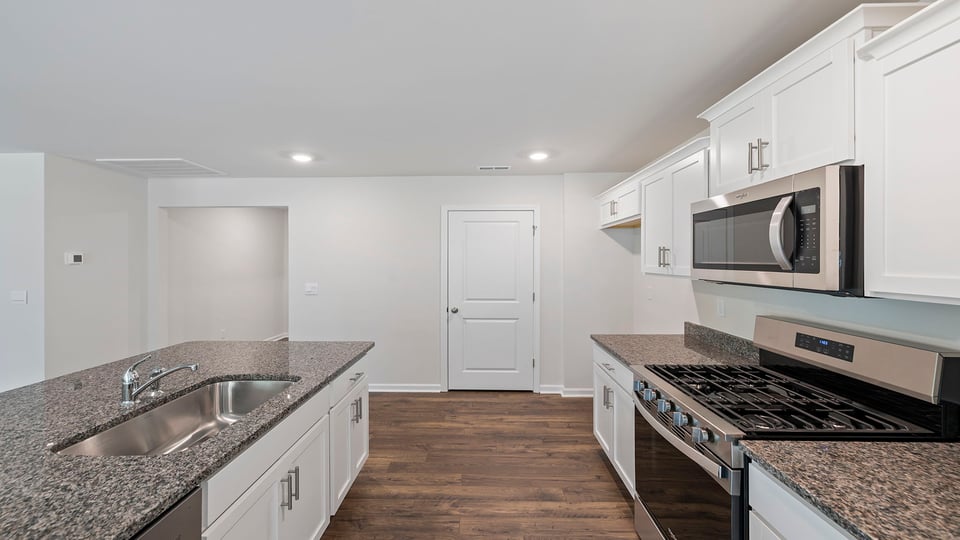 Kitchen and island with granite counter tops.