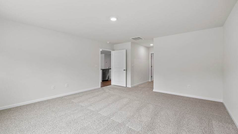 Bedroom with carpet and window.