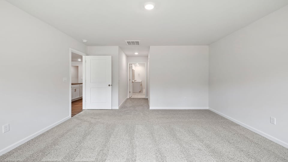 Bedroom with carpet and window.