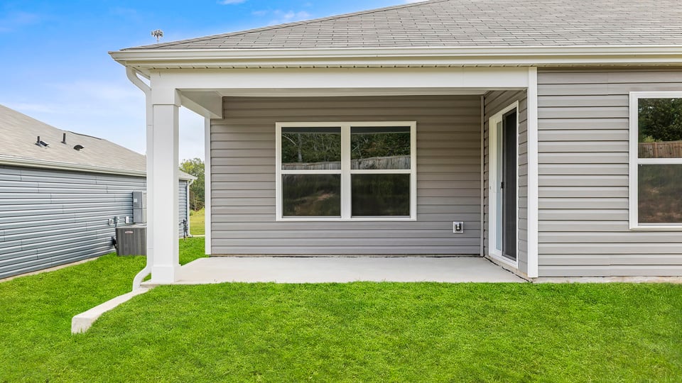 Exterior of home with large backyard.