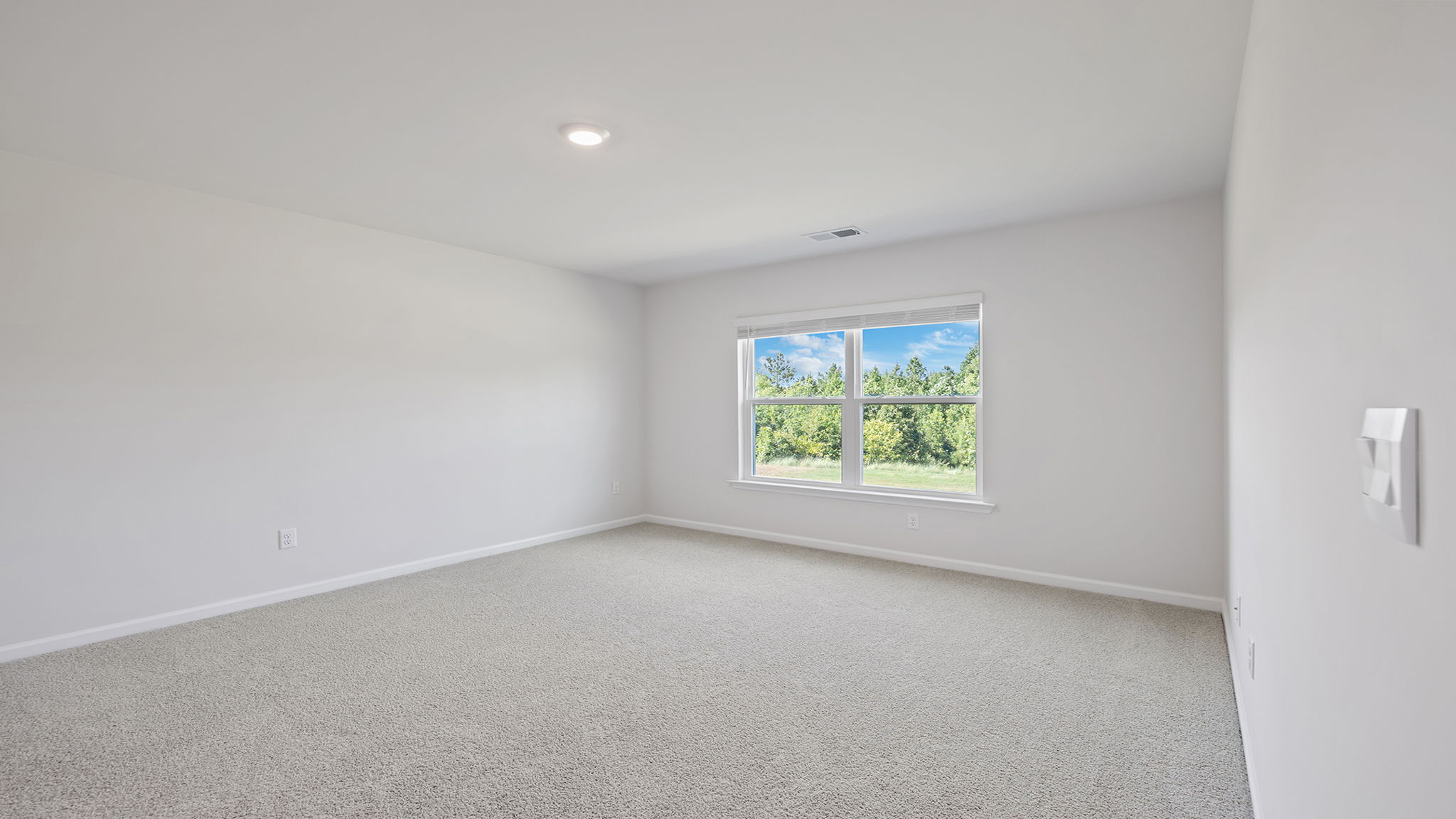 Bedroom with carpet and window.