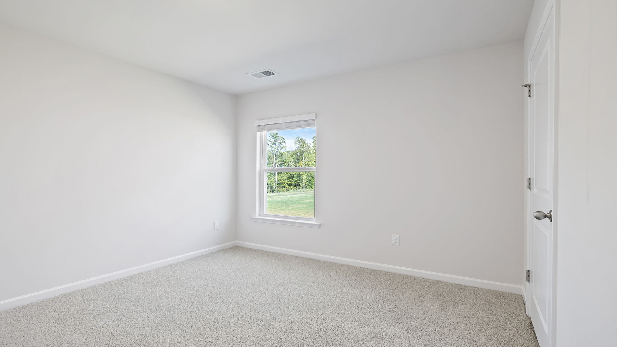 Bedroom with carpet and window.