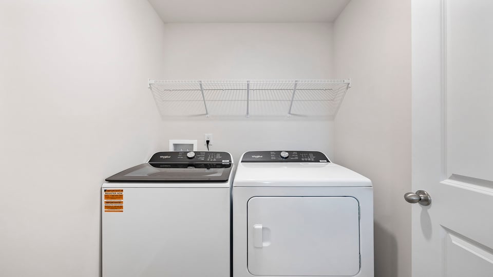 Walk in laundry with shelves.
