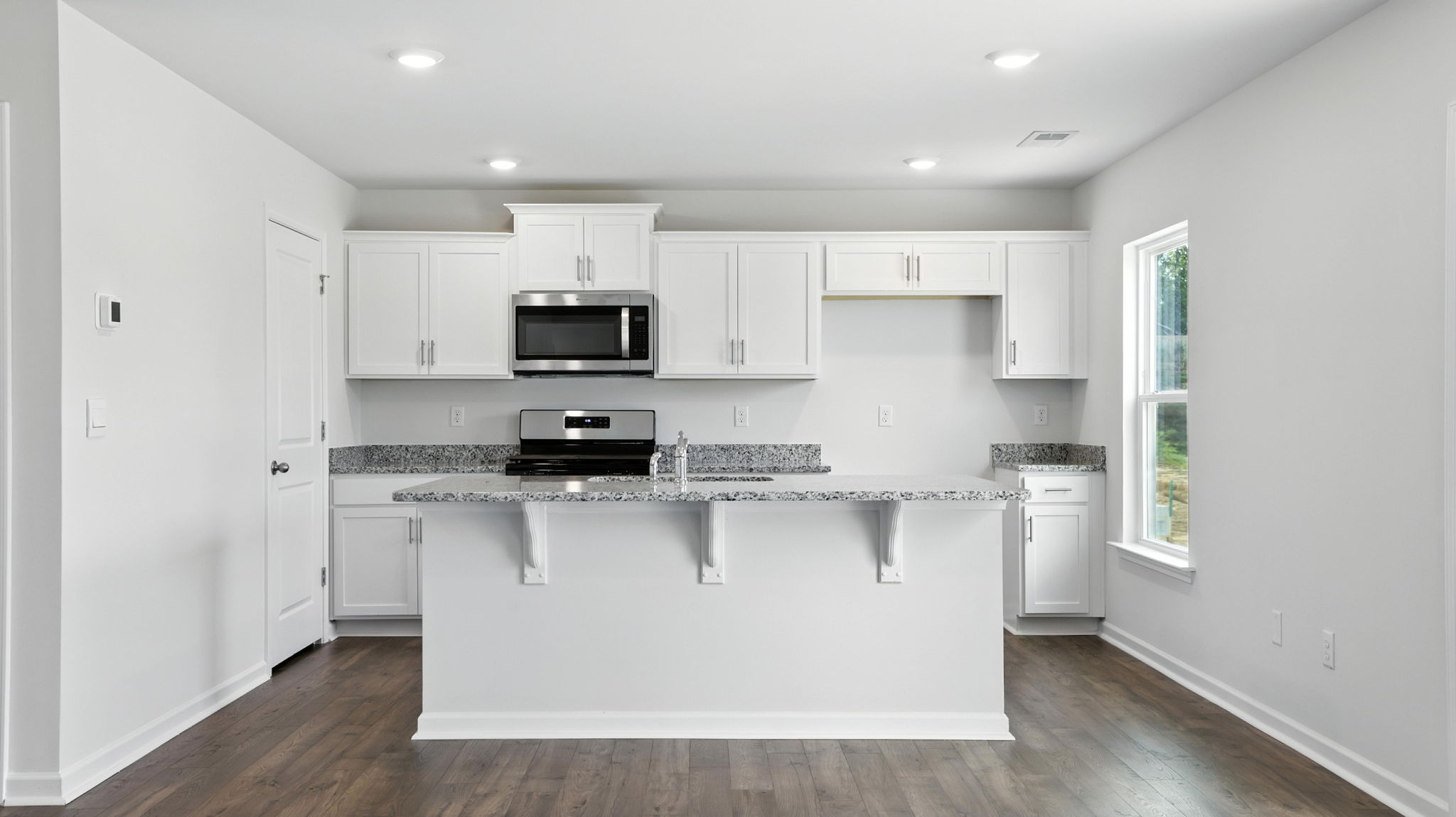 Kitchen with island and granite countertops.
