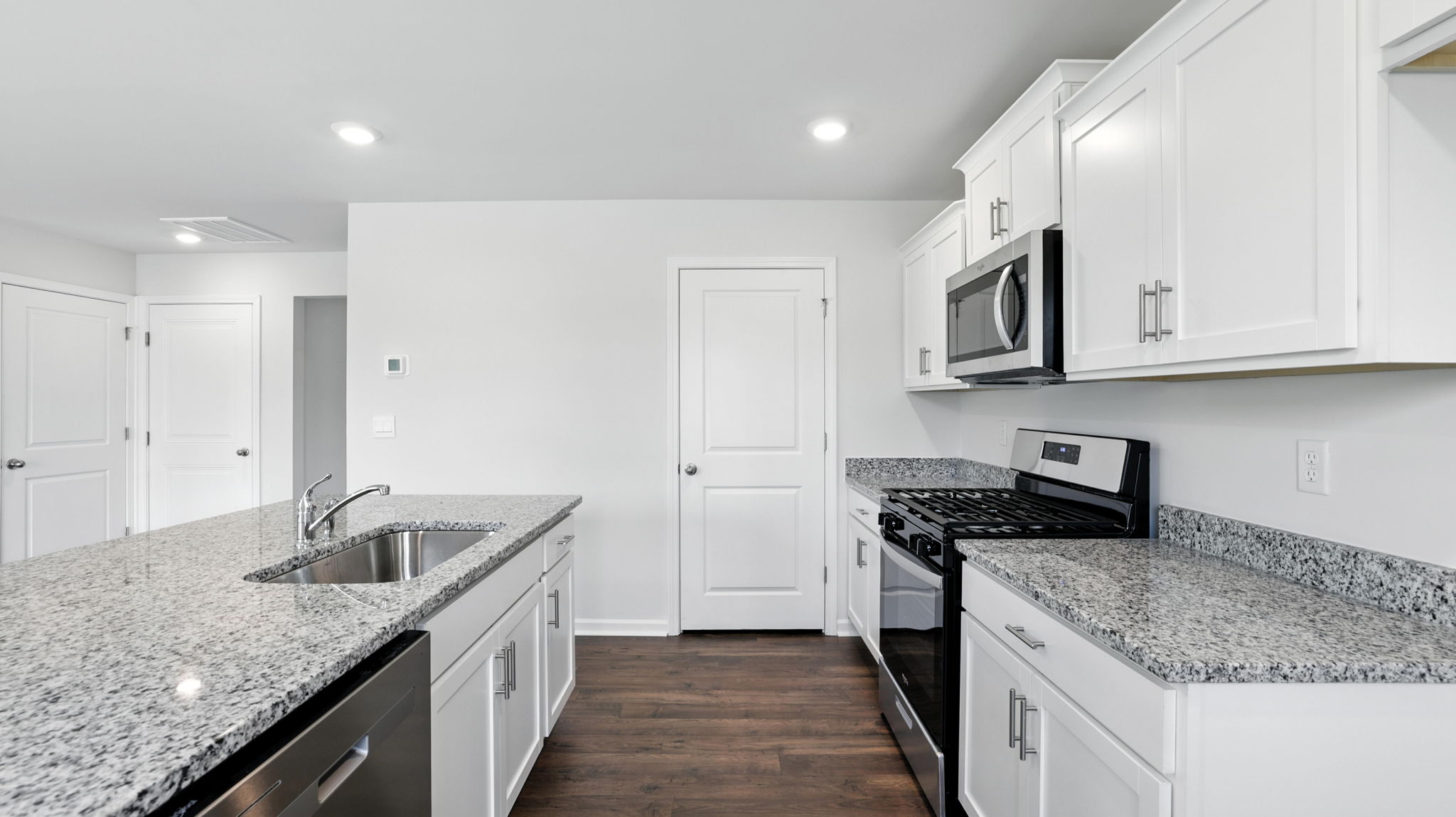 Kitchen with island and granite countertops.