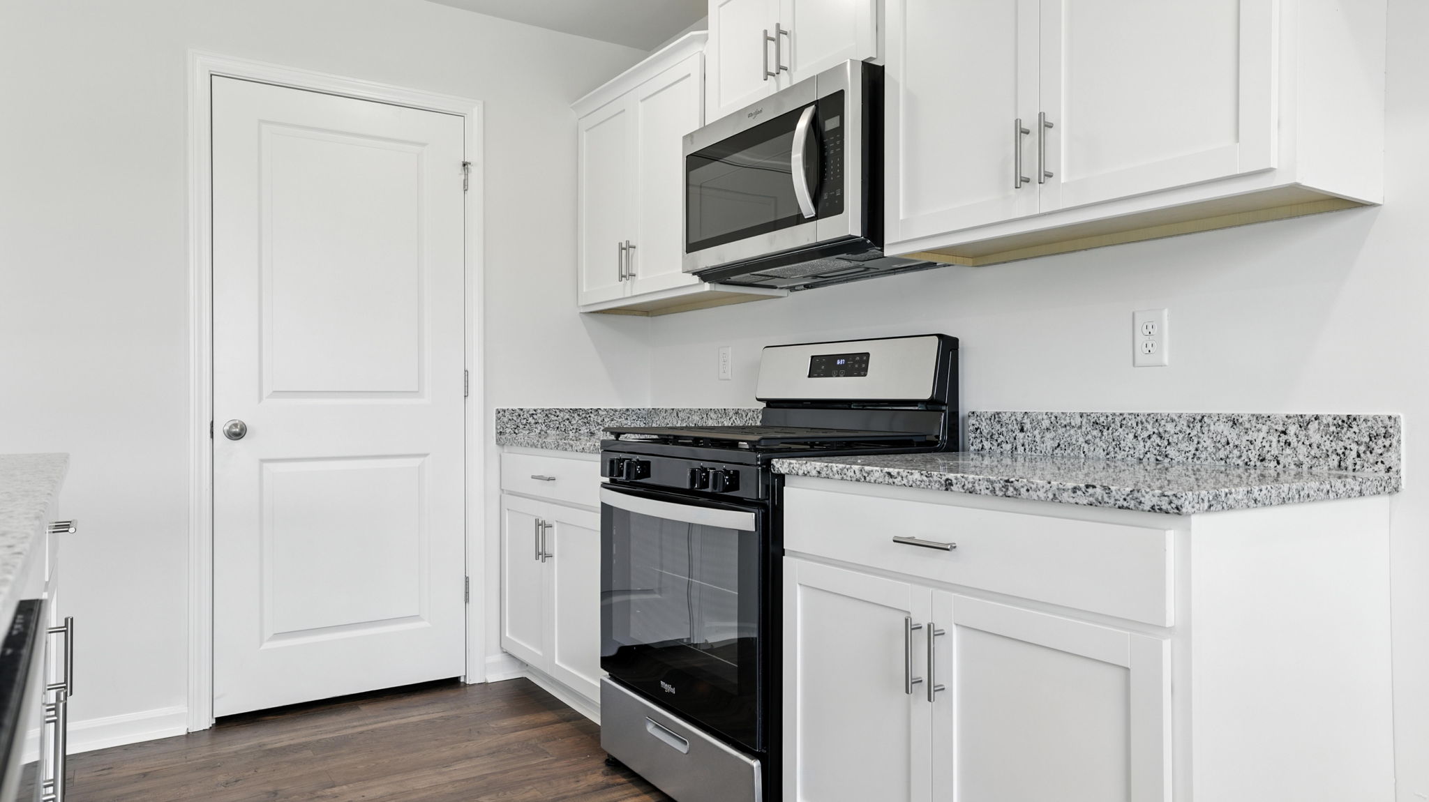 Kitchen with granite countertops and stainless steel appliances.