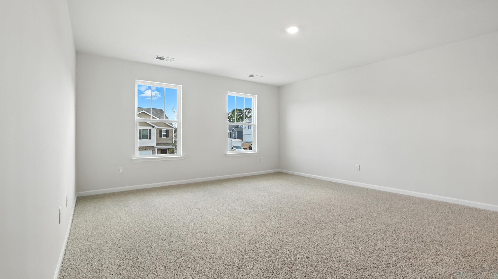 Bedroom with carpet and window.