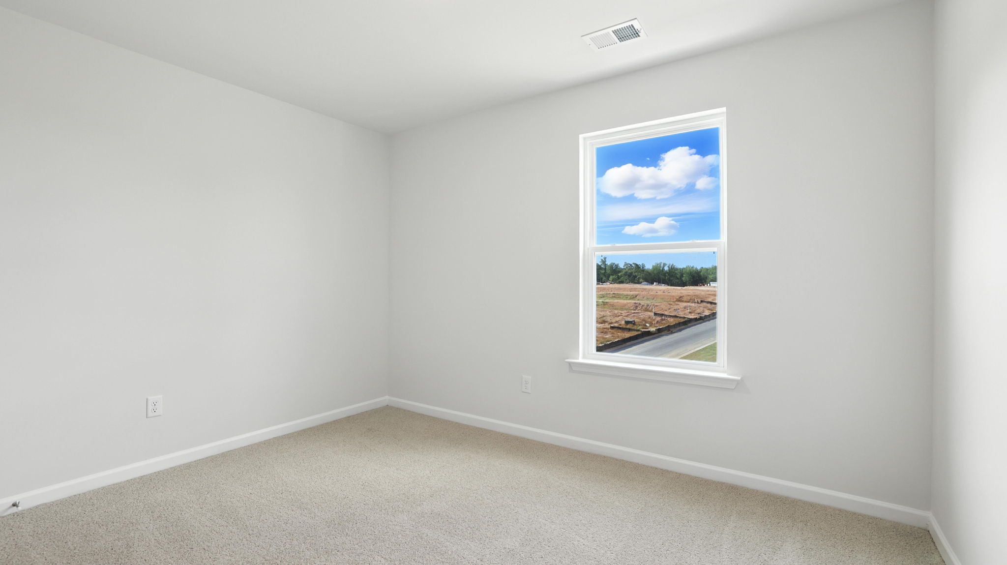 Bedroom with carpet and window.