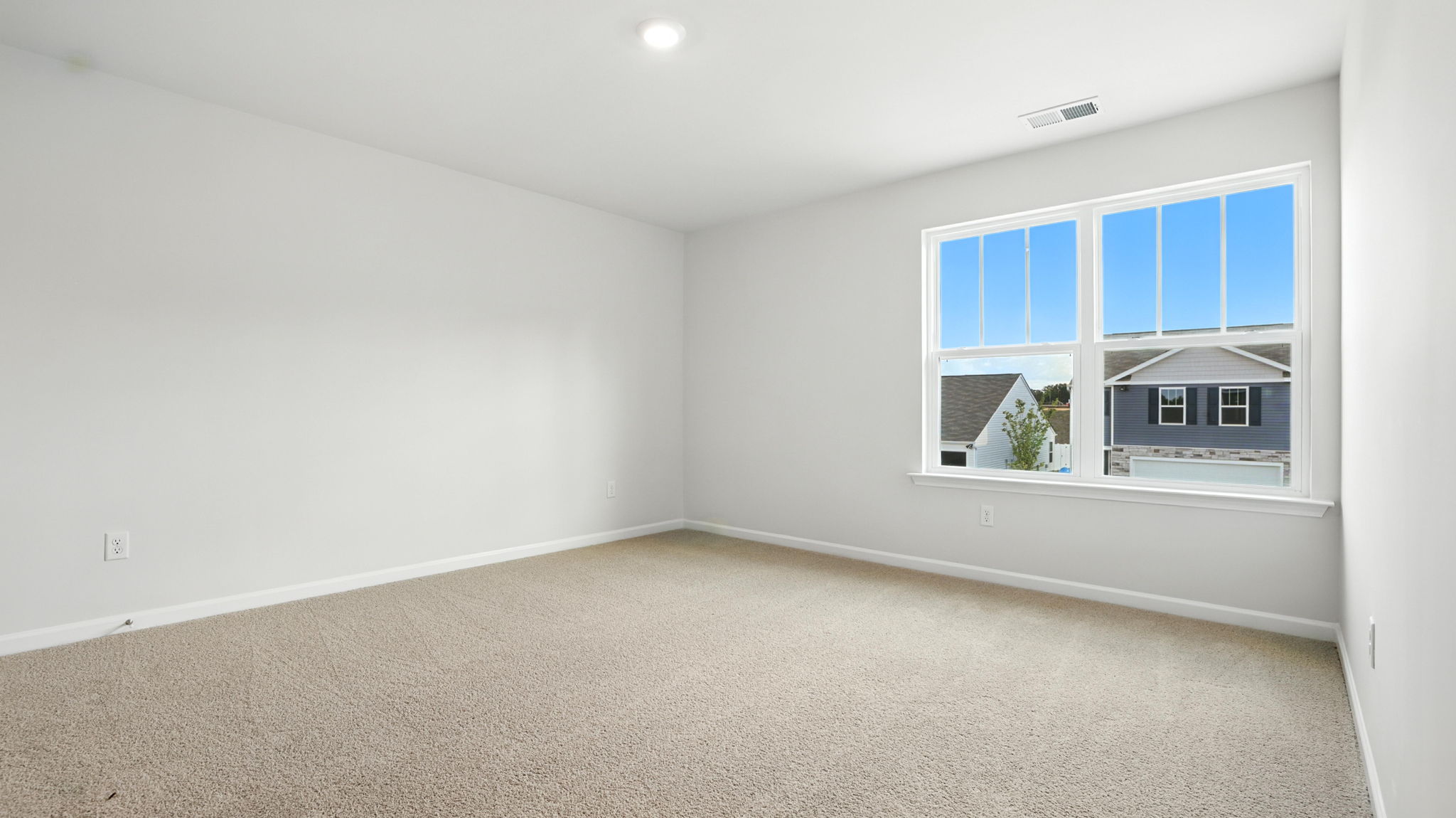 Bedroom with carpet and window.