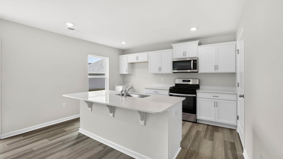 Kitchen and island with quartz countertops.
