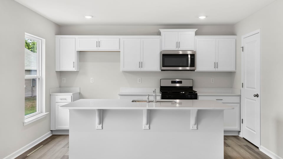 Kitchen and island with quartz countertops.