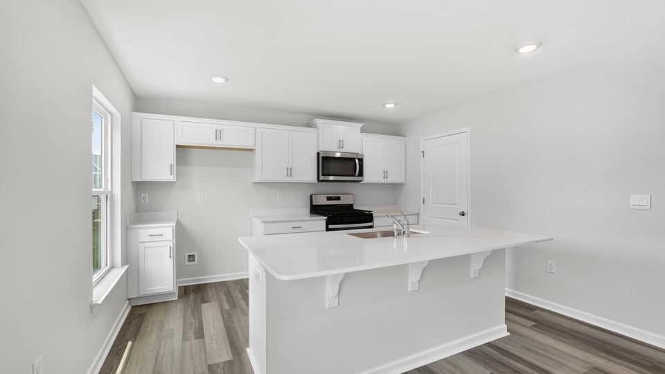 Kitchen and island with quartz countertops.