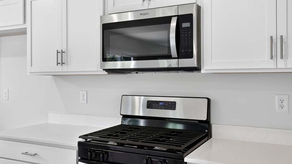 Kitchen and island with stainless steel appliances.