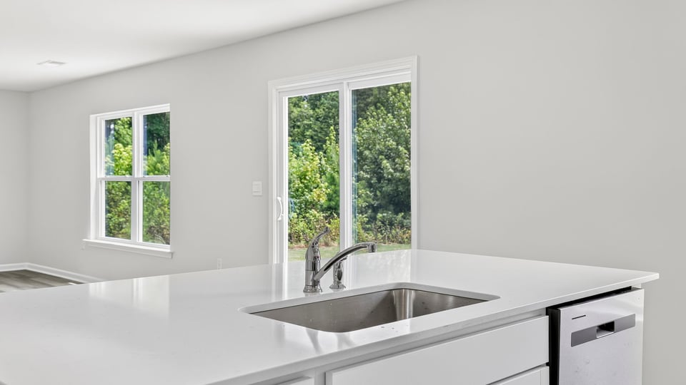 Kitchen and island with stainless steel appliances.
