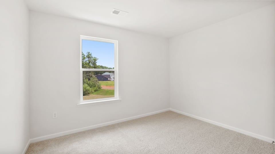 Bedroom with carpet and window.