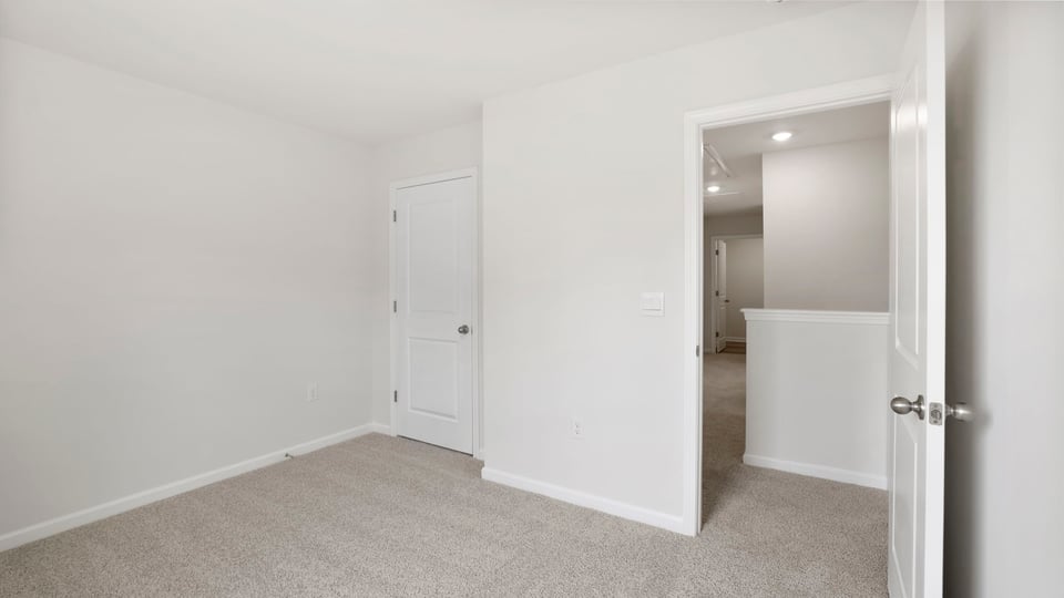 Bedroom with carpet and window.